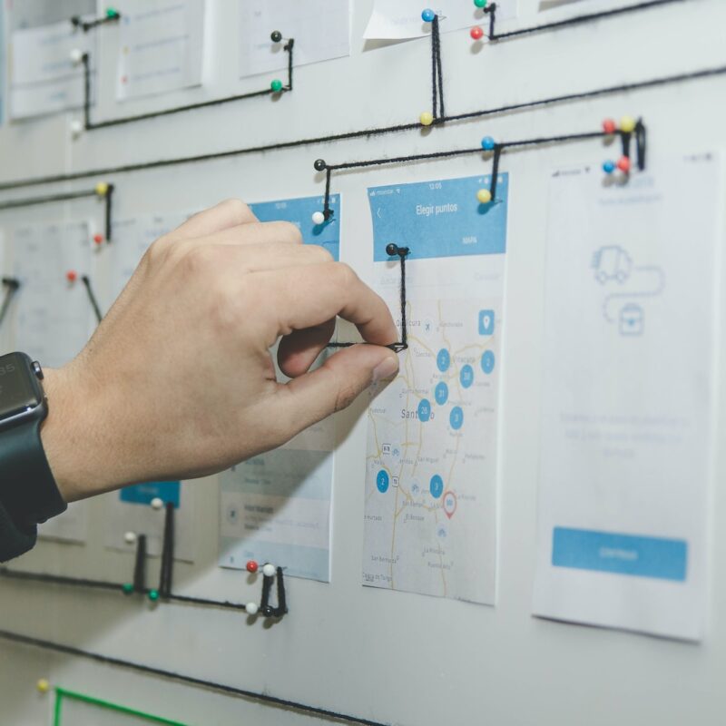 person working on blue and white paper on board